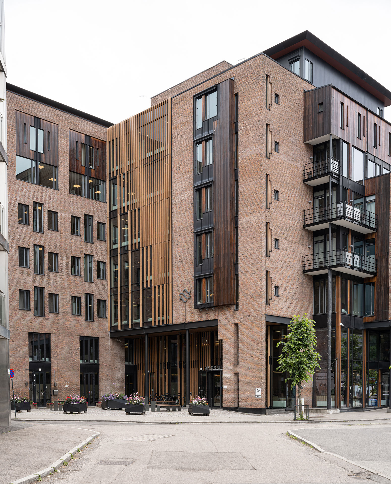 Moderne leilighetsbygning med murstein og tre