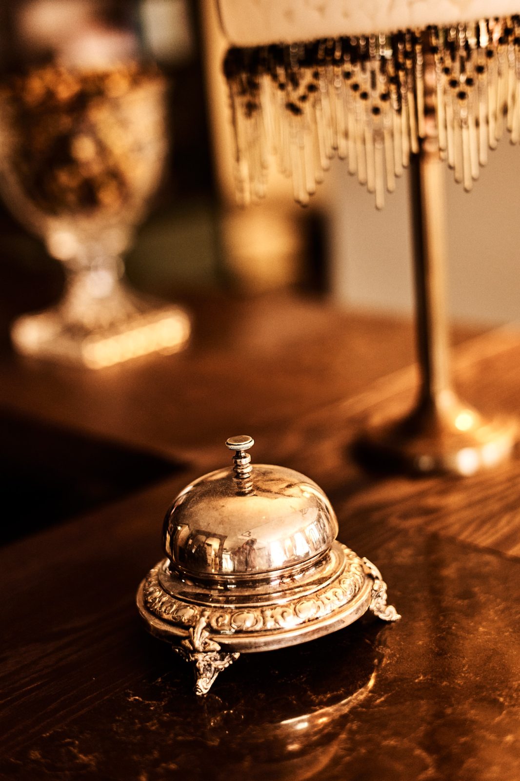 Vintage Bell and Crystal Lamp on Dark Surface